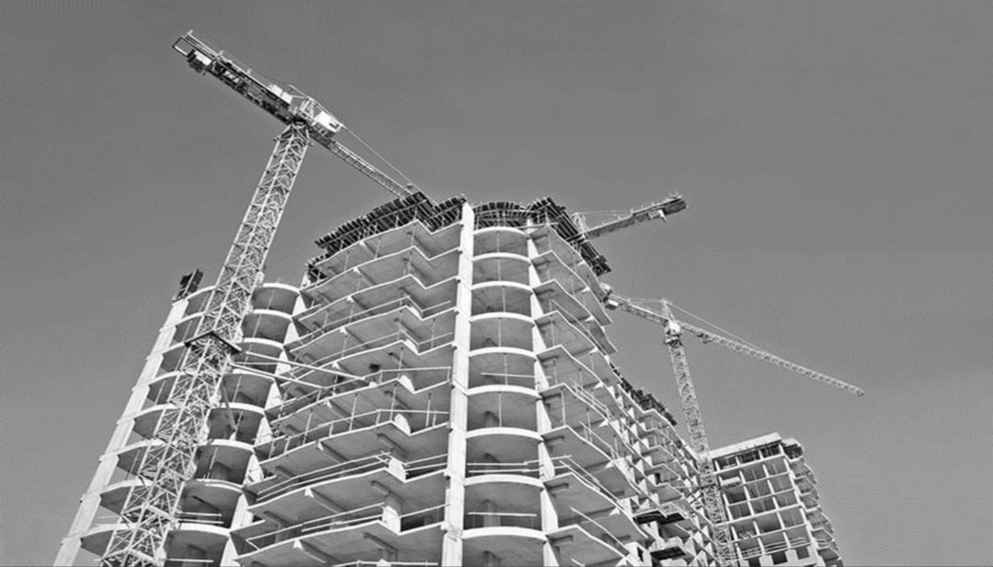 High-rise tower under construction with tower cranes