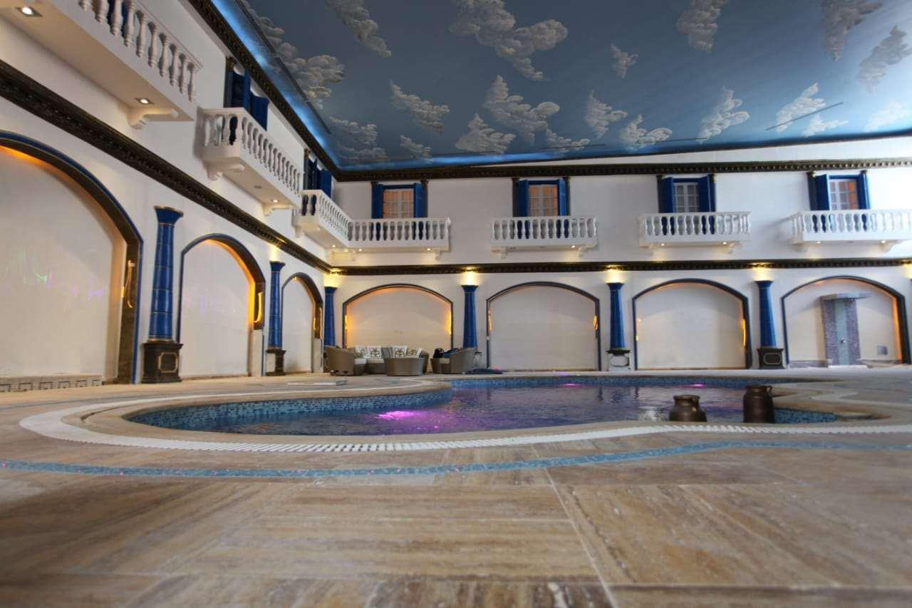 Palace courtyard pool with painted ceiling